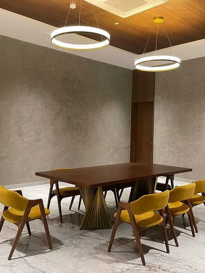 Another shot of the Tiripur dining set, showing the grand scale of the table and the comfortable, enveloping shape of the dining chairs.