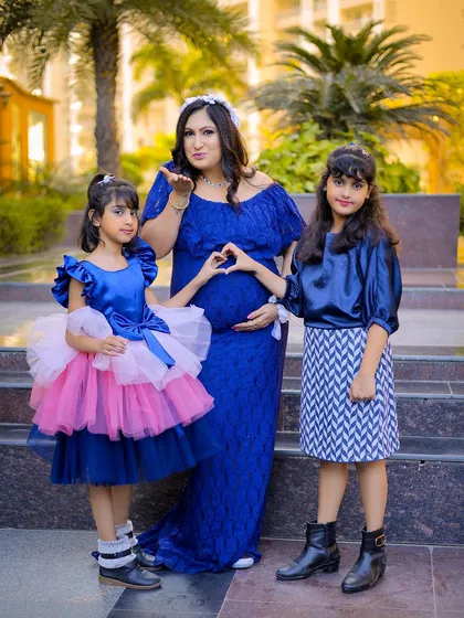 A maternity session is a family affair. Here, the mother-to-be celebrates with her two daughters, creating a beautiful memory before the new baby arrives.