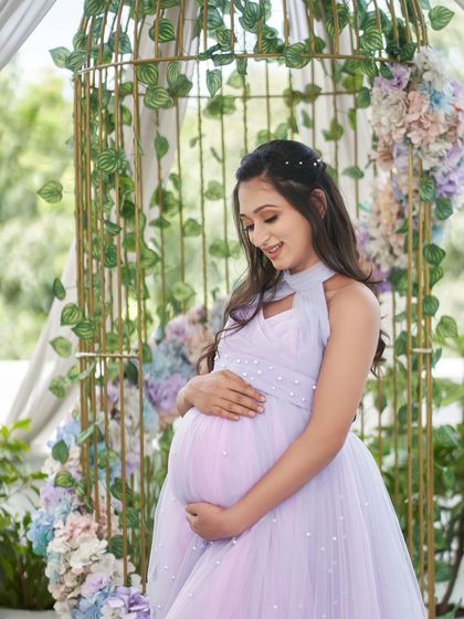 A close-up of the Breezy gown, showing the delicate pearl embellishments and the soft, flowing tulle.