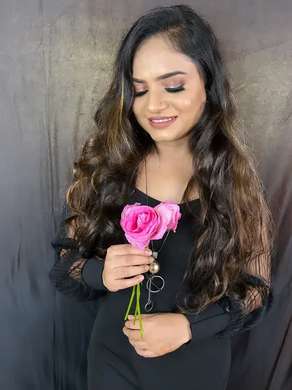 A soft and romantic party look. The gentle curls and pink-toned makeup create a very feminine and pretty vibe.