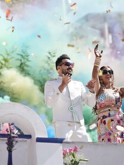 Part of our 'Around the World' carnival entry, this moment captures the couple celebrating with a burst of colorful smoke and confetti, creating a vibrant, joyous atmosphere.