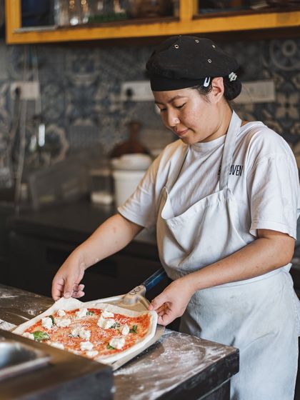 With care and precision, our chef arranges fresh, handmade mozzarella and basil on a San Marzano tomato sauce base before it heads into the oven.