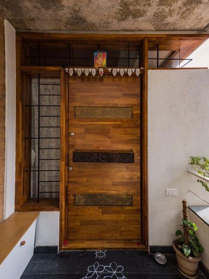 The entrance door of the Vruksha residence. We combined a piece of a traditional carved wooden beam with hand-embossed brass plates to create a unique, contemporary door with an antique soul.