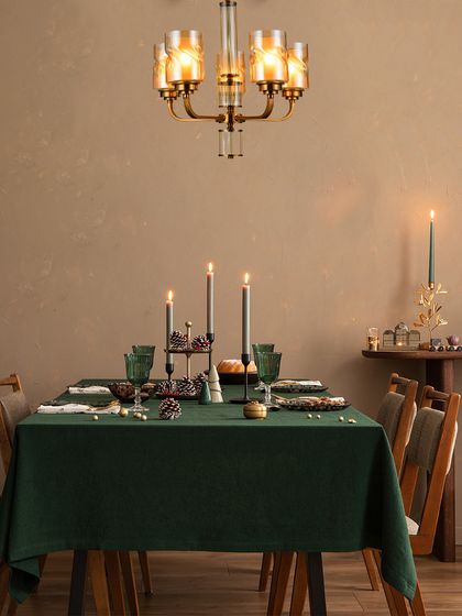A classic candelabra-style chandelier hangs over a festive dining table. This fixture adds a touch of traditional elegance, making the holiday meal feel even more special.