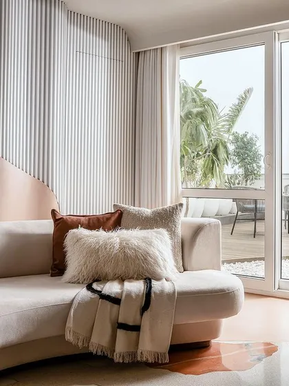 The living room opens up to a spacious party terrace, encouraging free movement from the indoors to the outdoors.