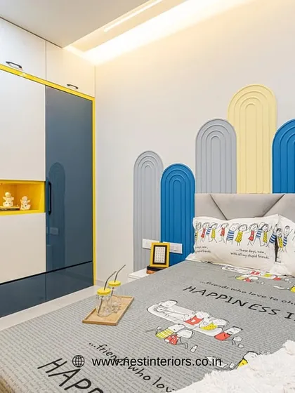 For this boy's room, I used a playful arched wall panel design behind the bed in shades of blue and yellow. The "Happiness Is" bedsheet adds to the cheerful and positive vibe of the space.