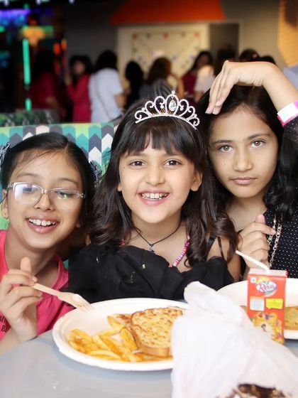 Candid shot of the birthday girl and her friends enjoying a meal at the party. We capture the fun moments shared between the children, not just the formal portraits.