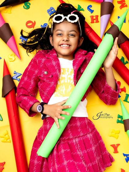 A bright smile against a vibrant yellow background. I use different colored backdrops within a single session to provide a wide variety of final images.