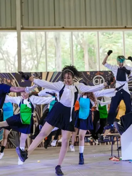 The entire crew hits a high-kick, showcasing their synchronization and energy.