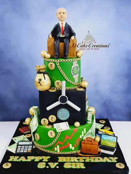 A three-tier corporate-themed cake for a boss's birthday. The design includes a money vault, stock market charts, and a figurine of the boss himself.