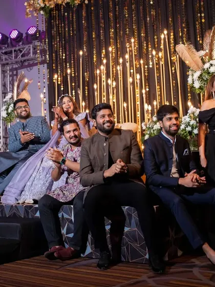 Guests enjoying the sangeet performances from the sidelines. We design the layout to ensure everyone has a great view of the stage and feels part of the action.