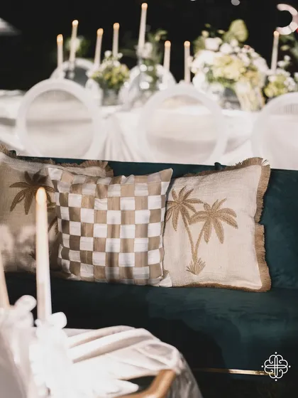 A detail of the lounge seating, with custom cushions and a view of the candlelit tables.