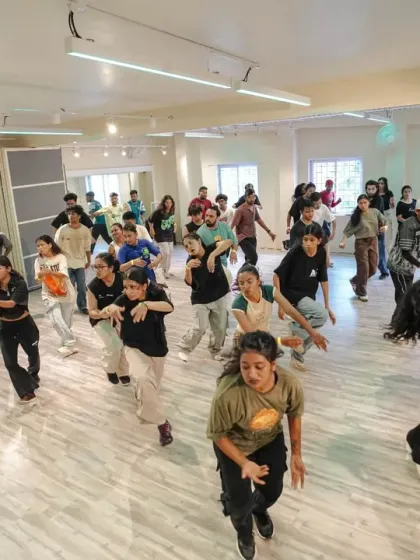 The whole studio is in motion. A dynamic shot of the entire class moving together during a high-energy Collab workshop.