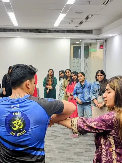 Demonstrating a simple wrist lock and escape during a corporate workshop. These techniques are easy to learn and don't rely on strength, making them perfect for everyone.