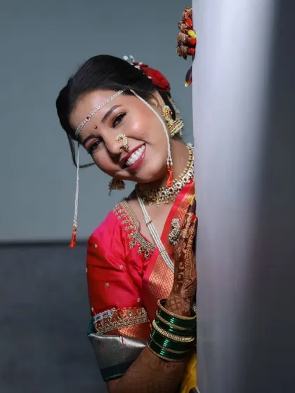 A playful peek from behind a wall. This candid shot captures the bride's joyful anticipation.
