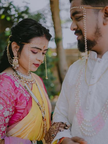 A quiet moment between the couple, highlighting the bride's profile and the delicate details of her wedding jewelry.