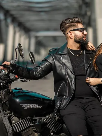 A cool and intimate portrait of the couple posing with their Harley Davidson on a bridge. This shot highlights their connection and shared style.