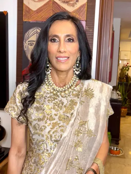 Sophisticated and chic. This mother of the bride's look features soft waves and a radiant complexion that highlights her beautiful features.