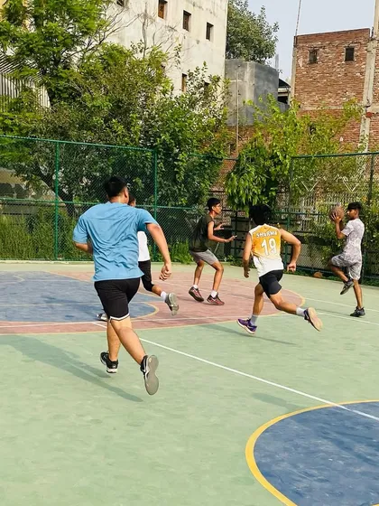 Players running a fast break. We drill our teams to push the pace and score easy baskets in transition.