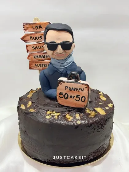 A 50th birthday cake for a travel lover, with a goal of visiting "50 by 50". The cake features a caricature and a signpost of destinations.
