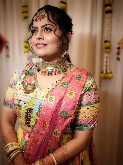 The complete Haldi look, with a colorful outfit and bold jewelry. The makeup ties everything together, creating a festive and joyful bridal style.