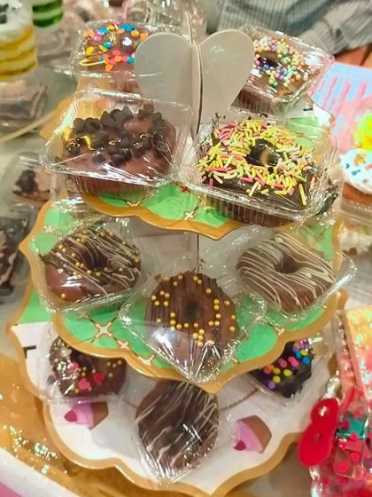Here are my mini donuts displayed on a cute stand at an exhibition. They are individually wrapped to keep them fresh and make them easy to serve at parties.