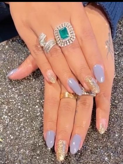 A sophisticated combination of periwinkle blue polish with accent nails in a dazzling gold glitter.