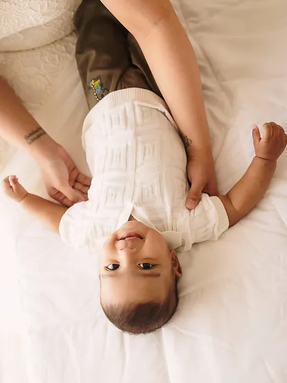 A playful, upside-down view of a happy baby. This candid shot is full of personality and shows the fun we have during our sessions.