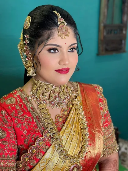 A close up portrait of a bride with a classic red lip and winged eyeliner. This timeless look is perfect for a traditional wedding ceremony.