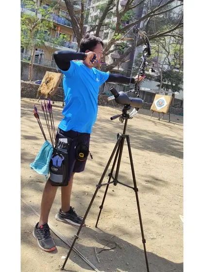 An archer uses a spotting scope to check his shots. We teach students to analyze their performance and make adjustments, an important part of self-correction and improvement.