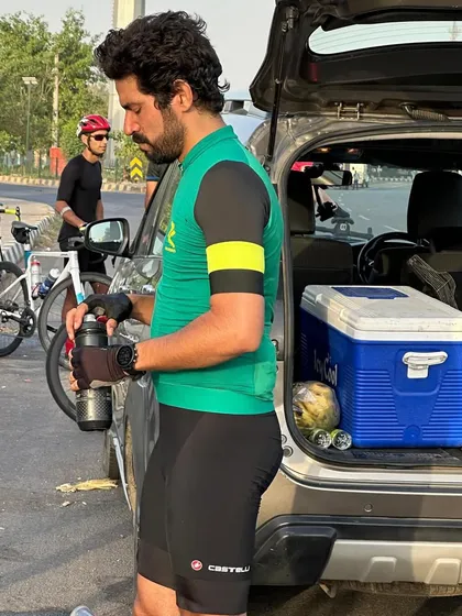 A member refilling his water bottle from a cooler. Staying hydrated is a team effort.