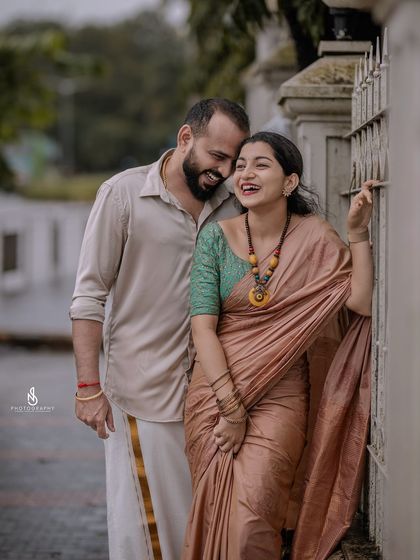 A cozy and happy embrace by a gate. This shot is full of warmth and genuine affection.