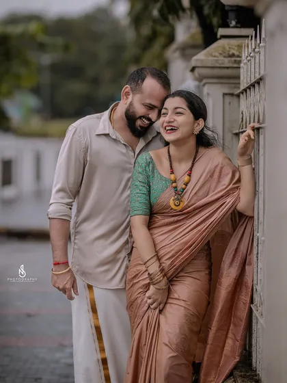 A cozy and happy embrace by a gate. This shot is full of warmth and genuine affection.