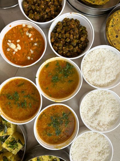 A simple, comforting meal of various dals, bhindi masala, and steamed rice.