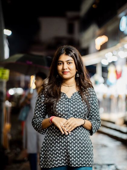 A classic half-body portrait. The soft focus on the background street scene makes the subject pop.