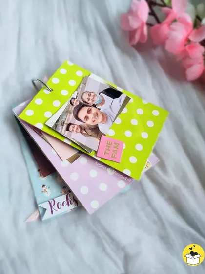 A stack of colorful mini tag books, each with a unique polka-dot design. These are great for collecting memories.