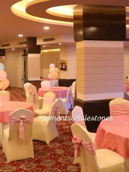 The guest seating area for the candy-themed party, with tables and chairs decorated in coordinating pastel colors.