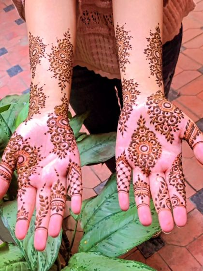 A delicate and intricate party mehendi design. The patterns are light and airy, featuring small mandalas and spaced-out motifs for a very pretty and feminine look.