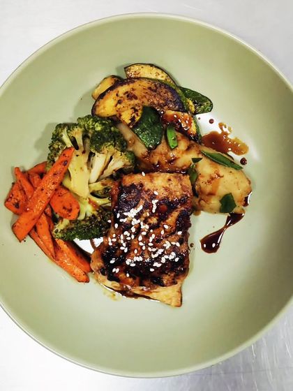 Japanese Umami Star: Miso Grilled Fish: Miso, a traditional Japanese seasoning made from fermented soybeans, brings an incredible depth of flavor. We use it to marinate and grill fish to perfection, served with sweet potato mash and sautéed summer veggies.
