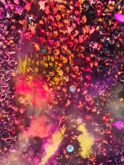 Another perspective of the color war during Holi. The mix of yellow, pink, and purple creates a stunning abstract image.