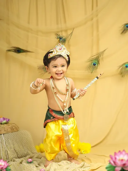So much joy in this little Krishna! Themed photoshoots for festivals like Janmashtami are so much fun. I love seeing the little ones light up when they get to dress up and play.