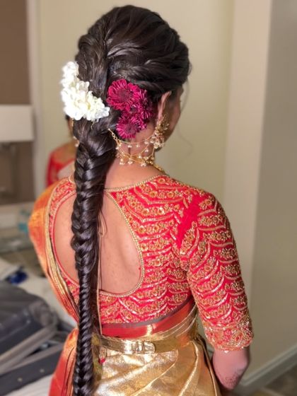 A still image of the beautiful fishtail braid with red and white flowers, showing the texture and color combination.