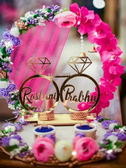 A beautifully decorated engagement ring platter, personalized with the couple's names. This detail shot captures the thoughtful and customized elements that make the ceremony special.