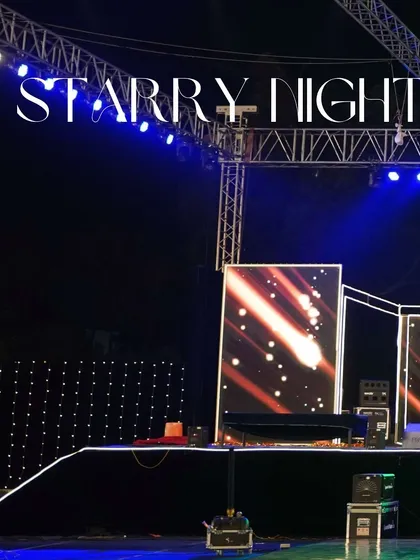 The stage for a 'Starry Night' themed event, featuring a large LED screen with cosmic visuals and a professional lighting rig. This setup is perfect for high-energy musical performances and DJ nights.