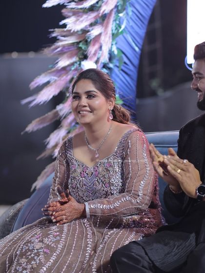 A candid moment from a sangeet night. Her makeup is designed to look beautiful from every angle, even in the midst of celebration.