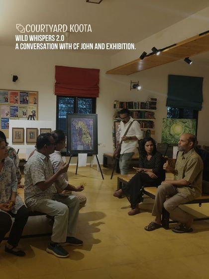 A conversation in progress during the "Wild Whispers 2.0" art exhibition with curator CF John. We believe in creating a dialogue between artists, their work, and the community.