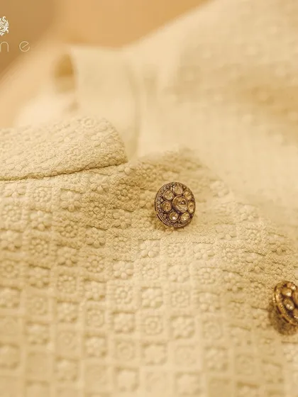 Another detail of the textured fabric and custom buttons. The self-woven pattern provides a rich canvas, making the buttons stand out as pieces of jewelry.
