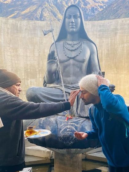 Receiving blessings before the Adiyogi statue in Kedarnath. A moment of surrender and connection to the source of yoga.