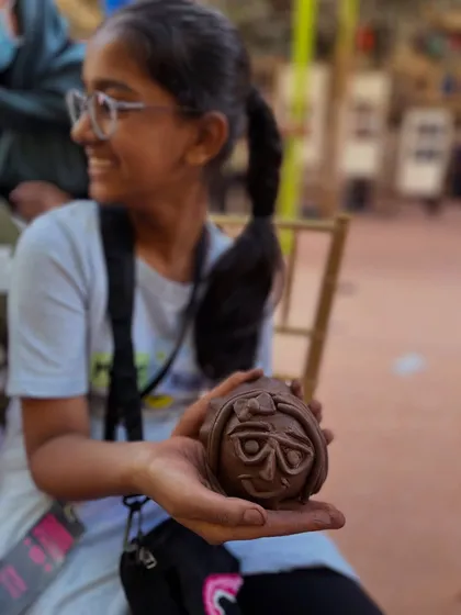 The pure joy on a young artist's face says it all. In our 'Clay-in-Faces' workshop, even the youngest students can create expressive, wonderful characters. This piece, full of personality, is a testament to the creativity that unfolds when we just play with clay.