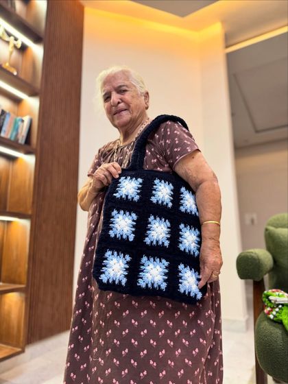 Dadi modeling our blue and white granny square tote. The color combination is so fresh and perfect for any season.